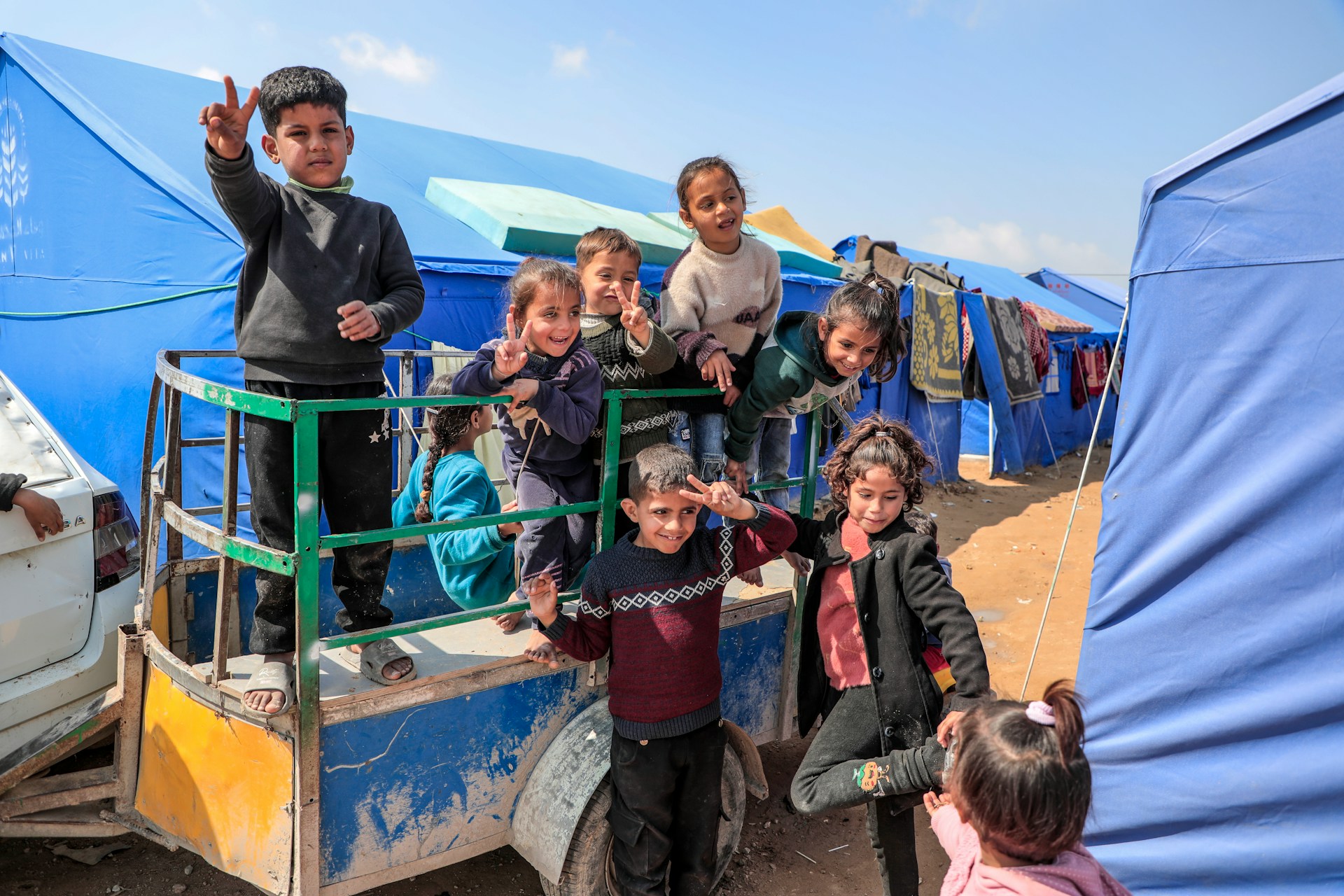Gaza - Palestine Children smile despite the suffering they experience every minute from the heat, lack of water, tents and diseases in a camp for displaced people in the northern Gaza Strip.